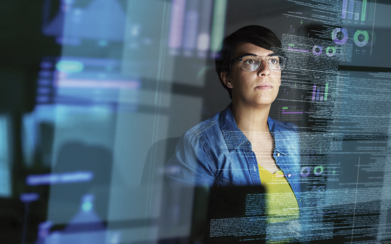 Woman Looking at Computer Algorithims iStock