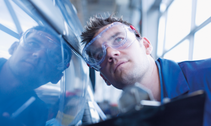 Technician inspecting car. CREDIT_iStock-88583403