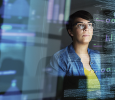 Woman Looking at Computer Algorithims iStock