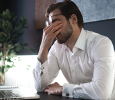 Tired young man feel pain eyestrain holding glasses rubbing dry irritated eyes fatigued from computer work.Shutterstock_2174737893