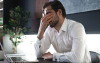 Tired young man feel pain eyestrain holding glasses rubbing dry irritated eyes fatigued from computer work.Shutterstock_2174737893