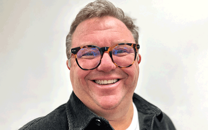 a headshot of a man smiling